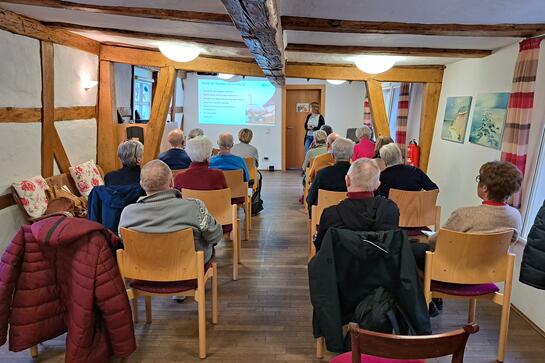 Die Teilnehmenden aus Bad Hersfeld sitzen und folgen der Präsentation von Theresa.